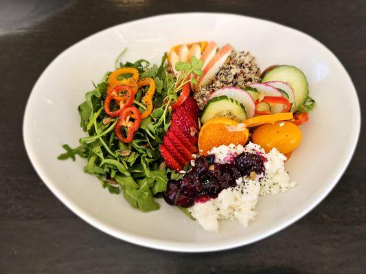 Cool Greens and Quinoa Salad with seasonal fruit, quinoa, greens, blueberry goat cheese, and seeds