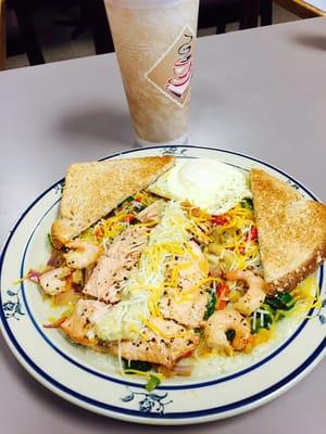 Dirty grits with shrimp and salmon and over easy eggs.