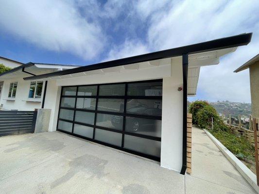 Black contemporary angle face gutter with 2x3 smooth downspouts