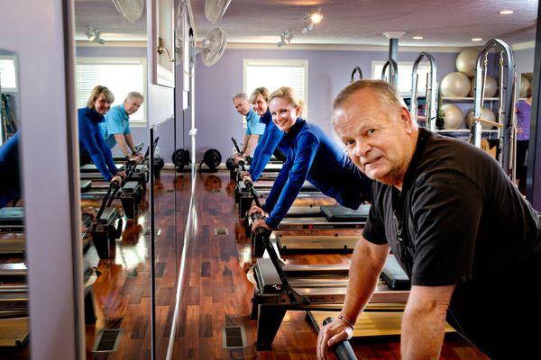 Men and women enjoy the group equipment-based classes