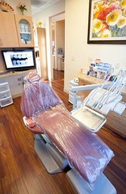 Clean, bright dentist treatment room with large windows