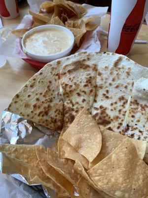 Quesadilla and chips with cheese dip.