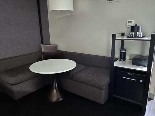 Seating area in room with mini fridge