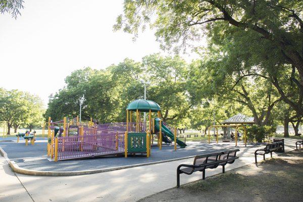 The large, mature trees cover most of the playground with ample shade.