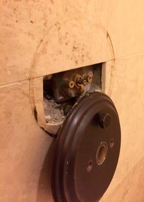 Shower valve hidden behind the travertine & inside cement.