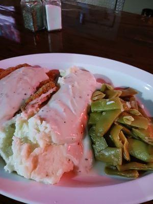 Country fried steak mashed potatoes and gravy with green beans