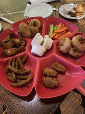 Sampler appetizer with wings, fried mushrooms, onion rings, fried green beans and jalapeño poppers