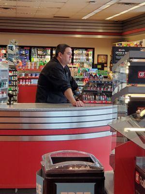 I visited a Quiktrip in Garland, TX on 11-March-21. And I was greeted with this cashier. No mask