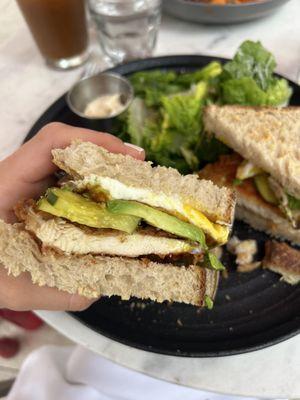 Fried chicken on sourdough added pickles and a fried egg on top.  Caesar Salad side