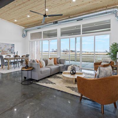 Living Room with floor to ceiling windows. Concrete heated floors, sliding glass doors that span the entire wall