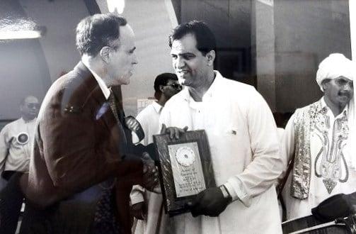 Hasain Shakil receiving a community service award from Mayor Giuliani.