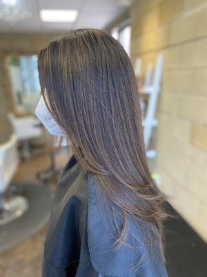 Long lightly layered haircut with subtle highlighting