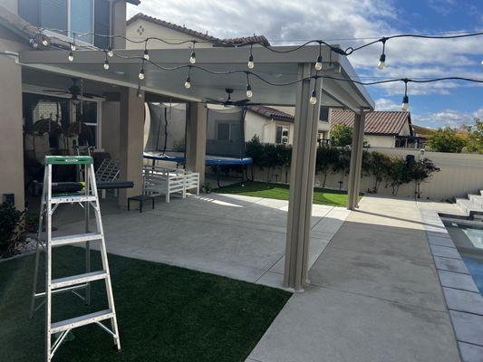 Great way to extend existing balcony by using matching colors and adding lights and fans