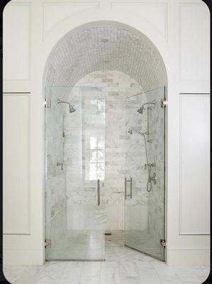 A pristine masterpiece, our completed bathroom showcases the allure of white marble and expansive glass.