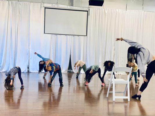 Kids Hip Hop class stretching in rehearsal.