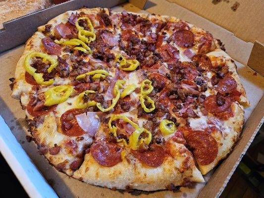 Meat Pizza with pepper rings on half