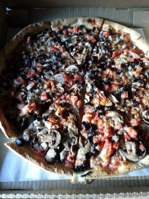 Large thin and crispy crust with mushrooms, olives and diced tomatoes.