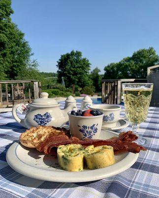 Delicious complimentary breakfast in the patio: black tea, pear juice, fresh fruit, English muffin, bacon, veggie omelet