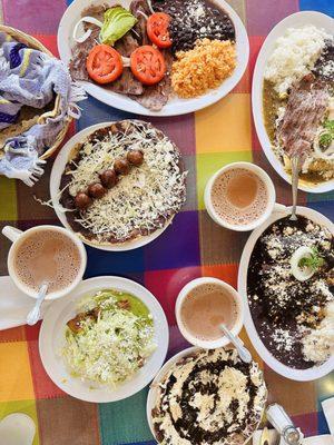 Memelitas, taquitos, enmoladas, carne asada and enchiladas campechanas and hot chocolate