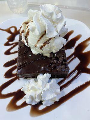 A warm brownie topped with ice cream & drizzled in chocolate syrup with whipped cream. Dee-lish.