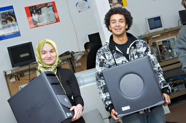 Volunteers with the computers they earned.