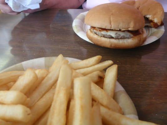 Cheeseburgers with hot sauce and fries.