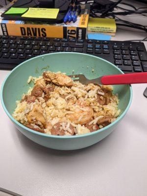 Jambalaya dumped into a bowl to mix it up a bit, distribute the sauce better.