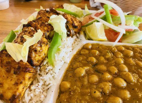 Mahi fish kabob served with chickpeas, salad, rice