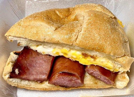 Kielbasa egg and cheese breakfast sandwich on a hard roll