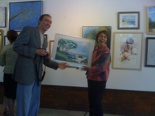 Instructor and student posing with her work for a photo