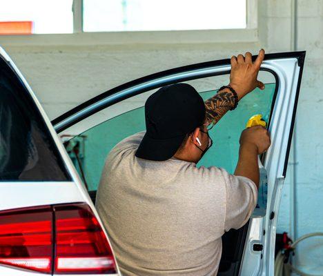 Window tinting services on a VW GTI.