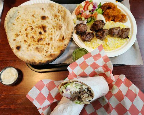 Naan, lamb kabobs on rice with green salad and spiced pumpkin