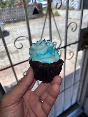 Blue frosting chocolate cupcake.