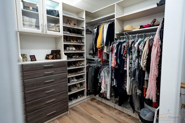 custom walk-in closet with hanging space, shoe fences, drawers, led lighting and glass doors, new york closets