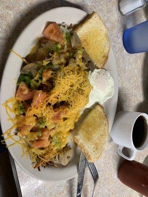 Delicious hash browns with veggies, fried egg and sourdough toast