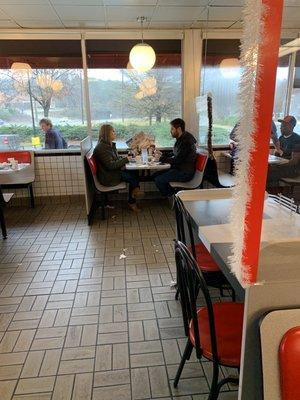 Notice the trash and food in the floor. Also the two dinners wearing COATS !!