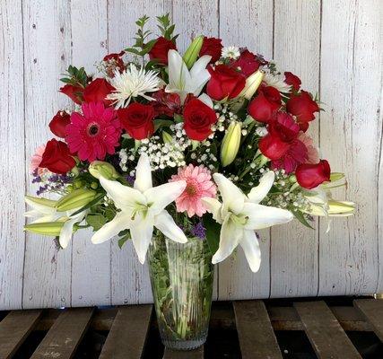 Show Stopper - a stunning display of Casa Blanca lillies, 18 roses, Gerbera daisies, limonium and more!