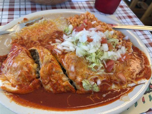 Beef burrito, smothered with red chili and garnish