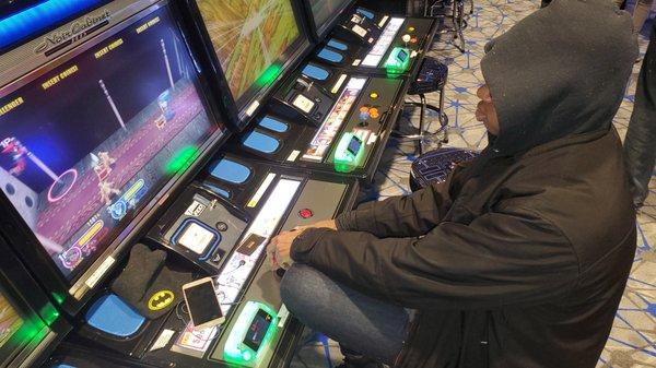 My brother playing Power Stone 2. Our childhood favorite game. Multiplayer game, but they only have one cabinet...?