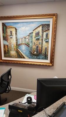 Nice painting behind the reception desk makes me daydream of traveling to Venice.