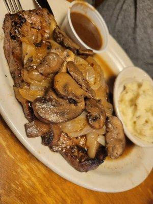 Ribeye smothered with mushrooms and onions with a side of mashed potatoes