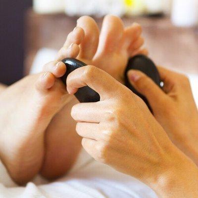 Hot stone treatment over the sensitive sector of your feet revigoration