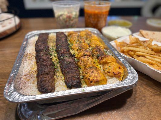 Family Meal with Beef Kubideh, Chicken Kabob, chickpeas, and chopped salad