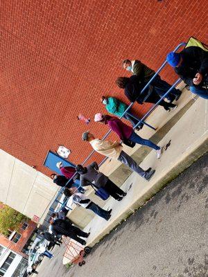 Line forming at Flushing poling place.  Around the back... Opens 12noon today! Hours different almost every day.