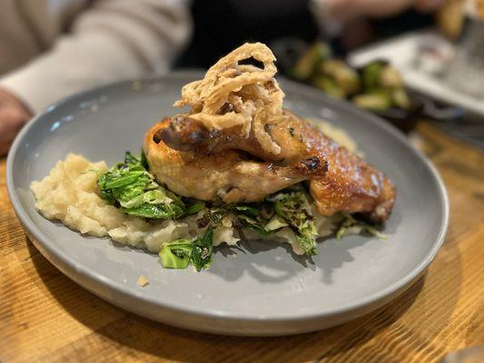 Slow Cooked Farm-Raised Half Chicken Roasted Garlic Scallions Mashed Potatoes, Shaved Brussels Sprouts, Lemon-Thyme Pan Jus, Crispy Onions