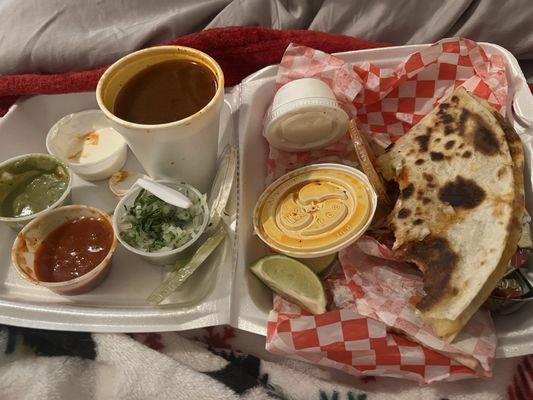 Dinner in bed  Birria Quesadilla, avocado cream sauce, salsa, onions and cilantro, sour cream, Comsome and lime.