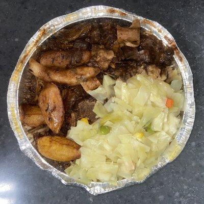 Oxtails, rice & peas under cabbage, fried plantains.