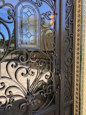 Detail work on install of Spanish tile around door frame and wainscoting inside portico.