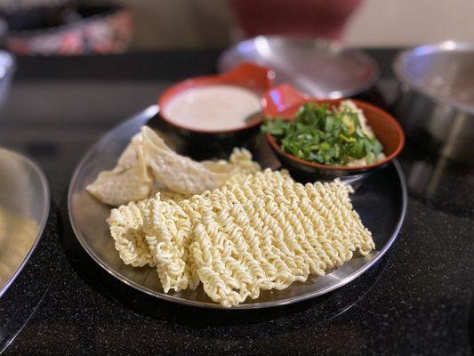 Ramen, dumplings, and special dipping sauce.