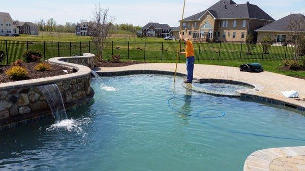 One of our pool technicians cleaning for an opening service visit.